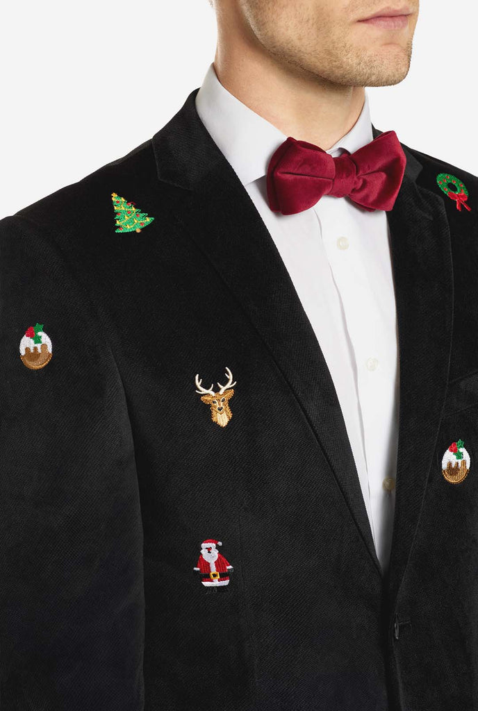 Man wearing burgundy red velvet Christmas blazer with Christmas icons, close up