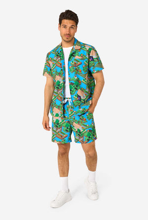 A man wearing a colorful summer outfit featuring a Minecraft Overworld print, showcasing pixelated landscapes, characters, and elements from the iconic game. The short-sleeve shirt and matching shorts highlight a vibrant design inspired by the Minecraft universe. Full body image