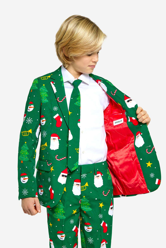Teen wearing green Christmas suit for teens, with Christmas icons.
