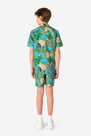 A Teen boy wearing a colorful summer outfit featuring a Minecraft Overworld print, showcasing pixelated landscapes, characters, and elements from the iconic game. The short-sleeve shirt and matching shorts highlight a vibrant design inspired by the Minecraft universe. View from the back