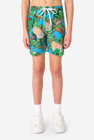 A Teen boy wearing a colorful summer outfit featuring a Minecraft Overworld print, showcasing pixelated landscapes, characters, and elements from the iconic game. The short-sleeve shirt and matching shorts highlight a vibrant design inspired by the Minecraft universe. Close up shorts
