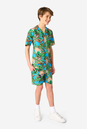 A Teen boy wearing a colorful summer outfit featuring a Minecraft Overworld print, showcasing pixelated landscapes, characters, and elements from the iconic game. The short-sleeve shirt and matching shorts highlight a vibrant design inspired by the Minecraft universe. Full body image