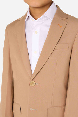 Kid wearing a stylish light brown/ beige suit with a white dress shirt, looking away from the camera. Perfect formal outfit for boys' special occasions, weddings, and parties. Chest close up.