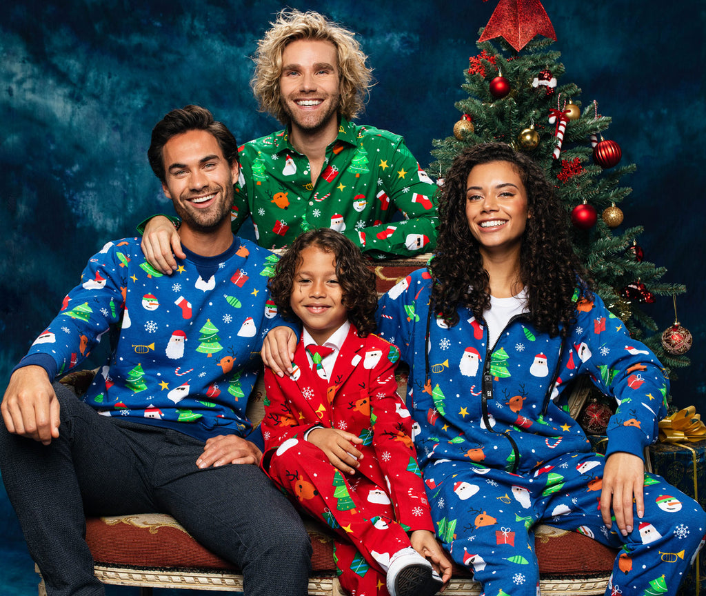 Group of people wearing OppoSuits clothing with Christmas tree in back ground