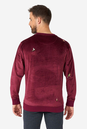 Man wearing velver burgundy red Christmas sweater with Christmas icons