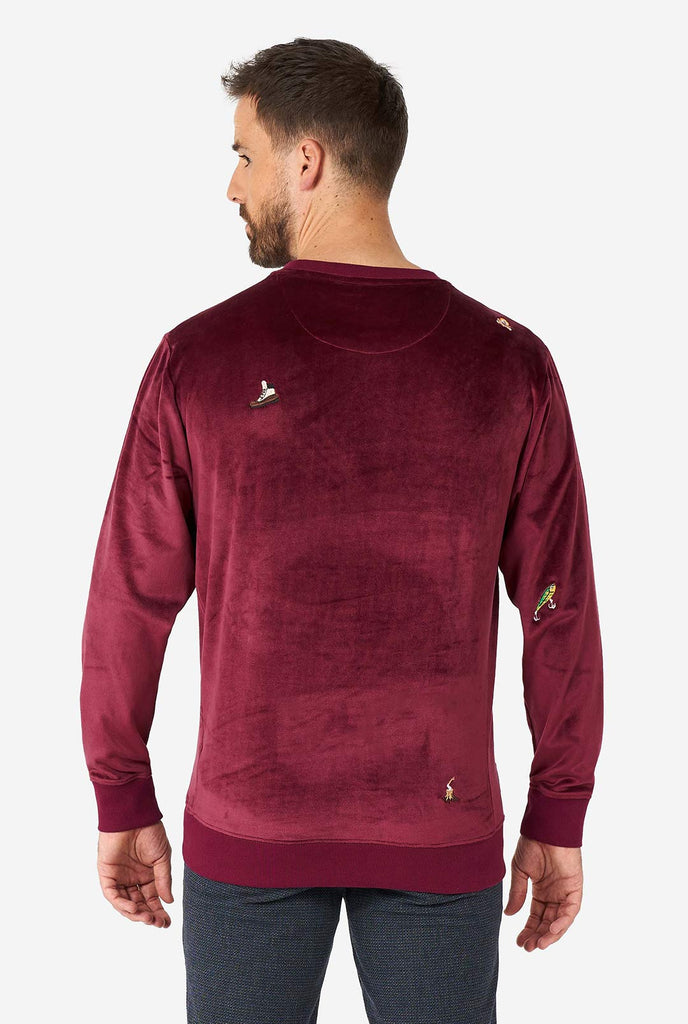 Man wearing velver burgundy red Christmas sweater with Christmas icons