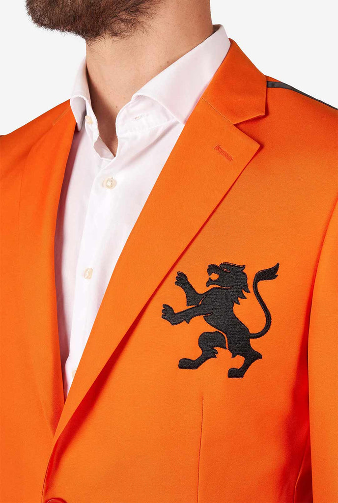 Man wearing orange blazer with dutch lion