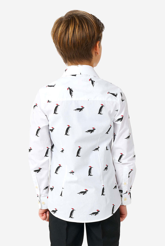 White Christmas dress shirt with Christmas penguins worn by a boy zoomed in