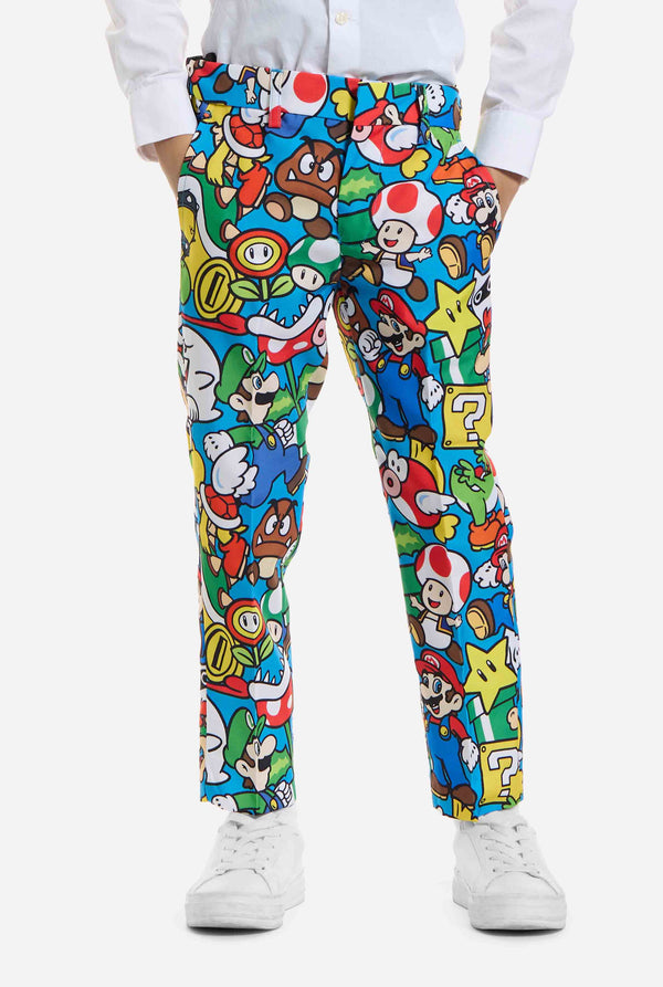 Image of kid wearing a Super Mario all over print suit, consisting of blazer, pants and tie. Main color is blue, but there is also yellow, red and white.