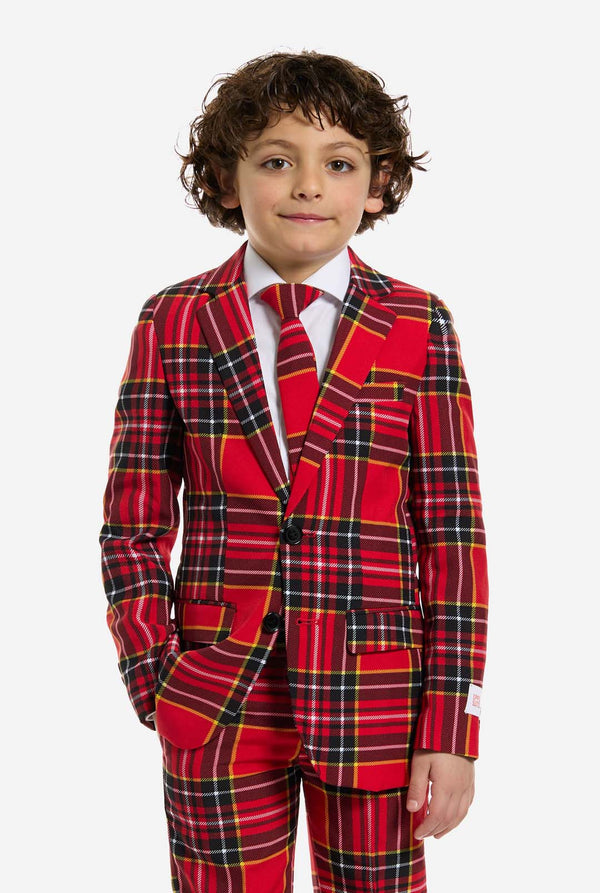 Child wearing a red plaid suit on a white background