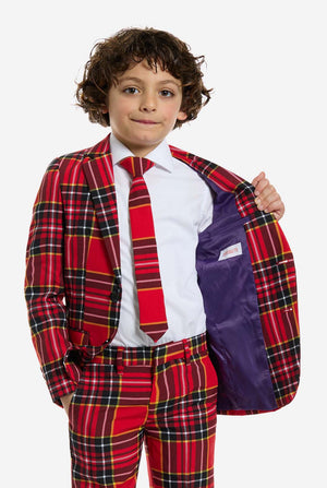 Child wearing a red plaid suit with a purple jacket over white shirt