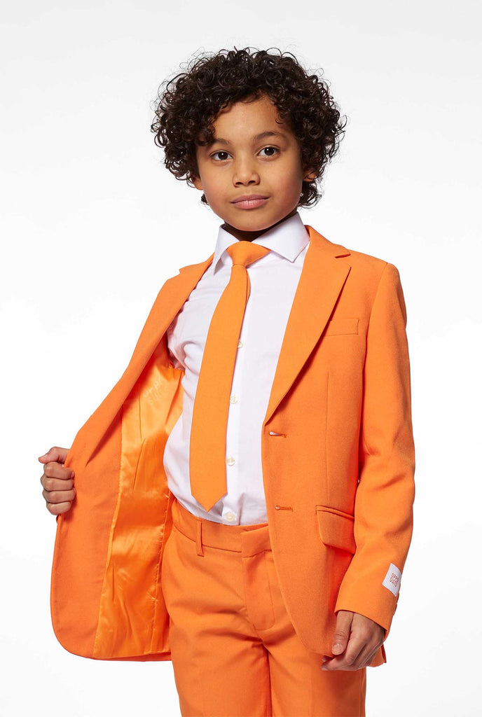 Solid colored orange boys suit worn by boy