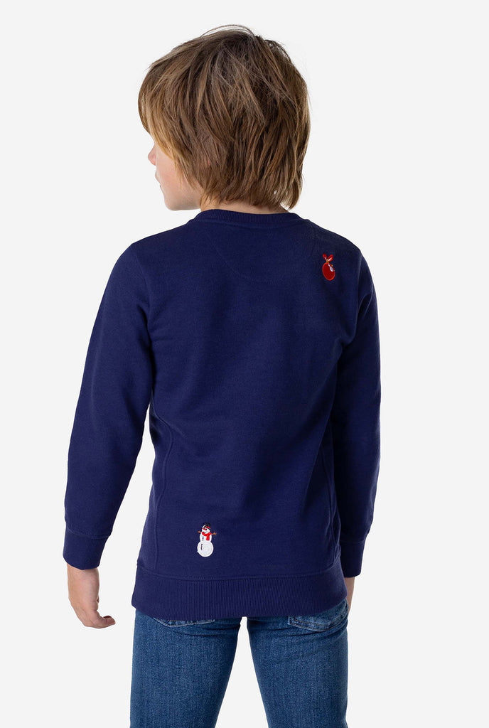 Kid wearing blue Christmas sweater with Christmas icons