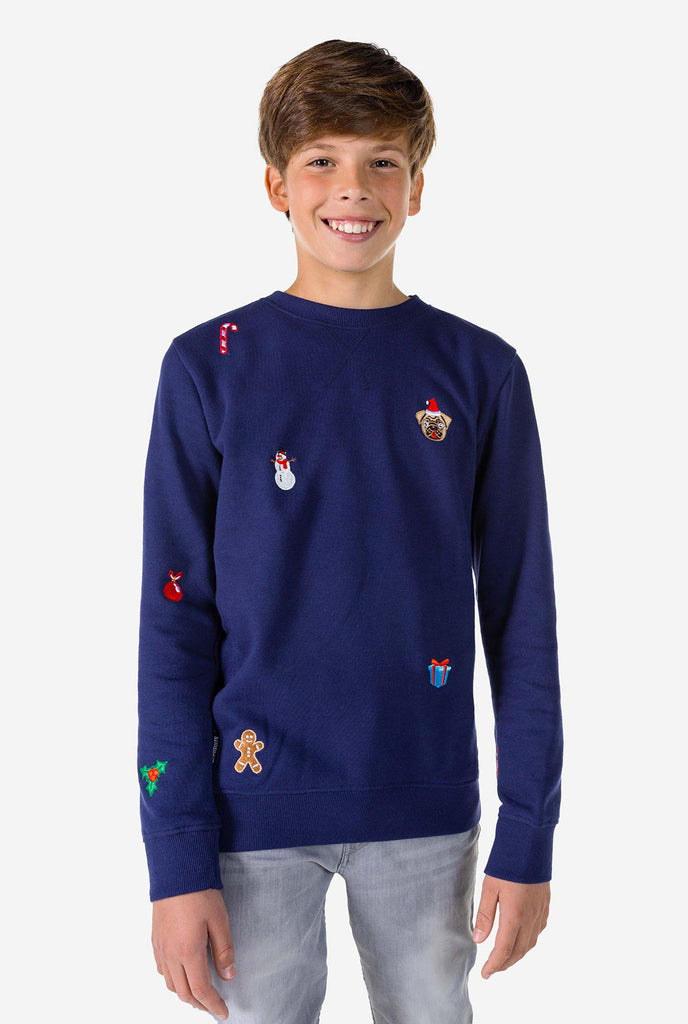 Kid wearing blue Christmas sweater with Christmas icons