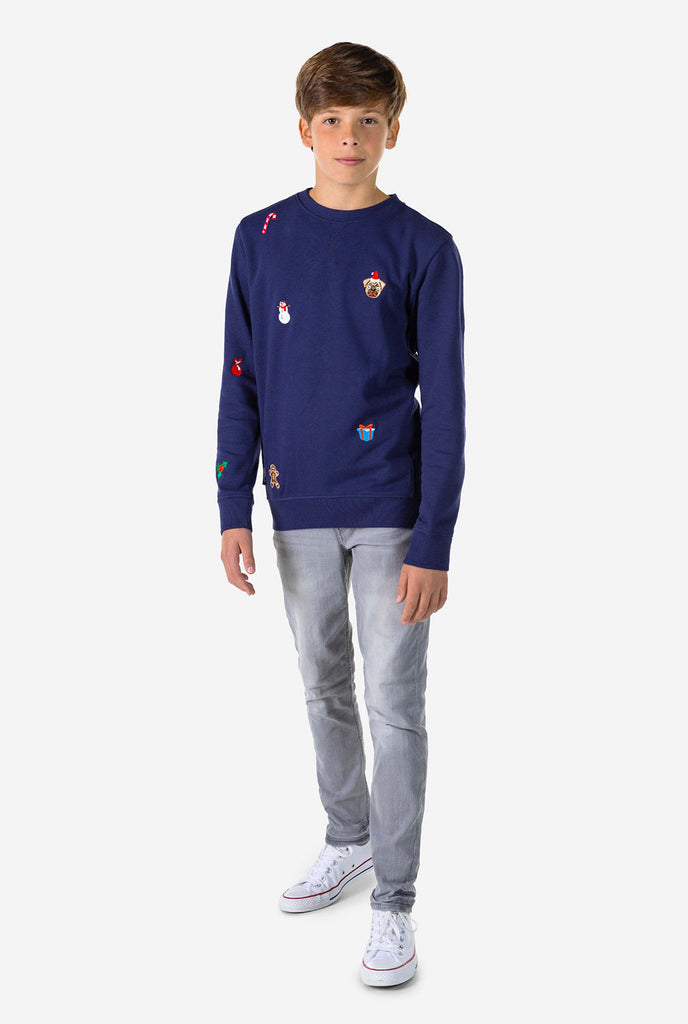 Kid wearing blue Christmas sweater with Christmas icons