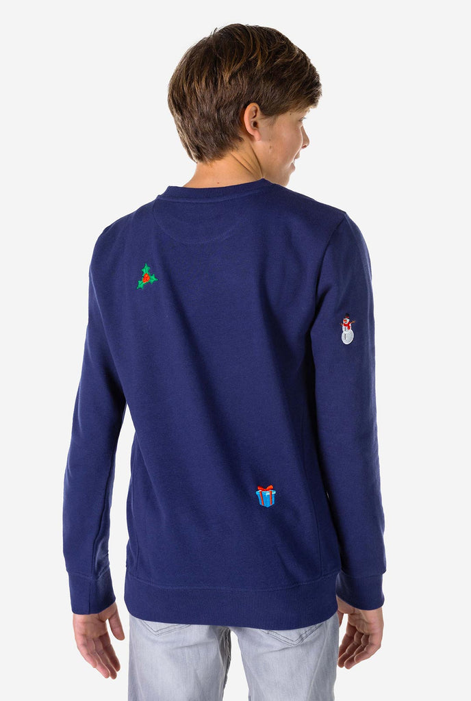 Kid wearing blue Christmas sweater with Christmas icons