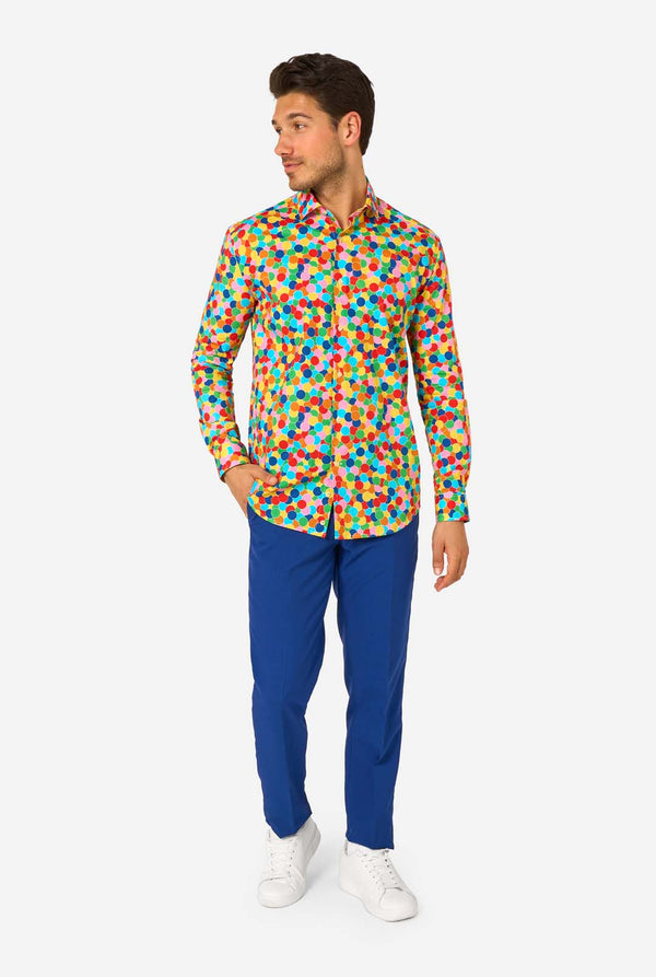 Man wearing a colorful polka dot confetti shirt on a white background. Full body image