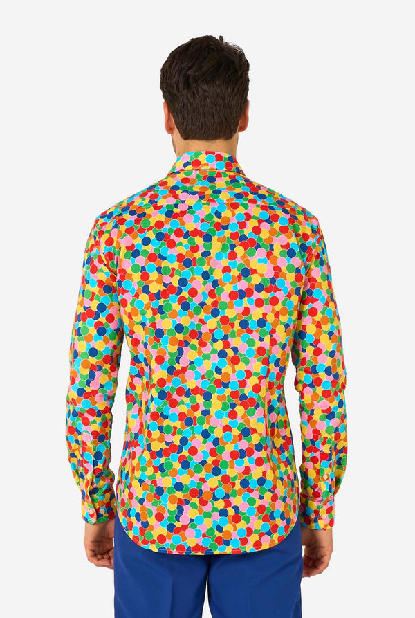Man wearing a colorful polka dot confetti shirt on a white background. View from the back