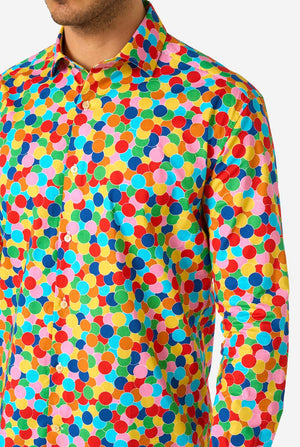 Man wearing a colorful polka dot confetti shirt on a white background. Close up of the chest