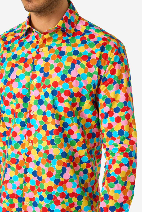 Man wearing a colorful polka dot confetti shirt on a white background. Close up of the chest