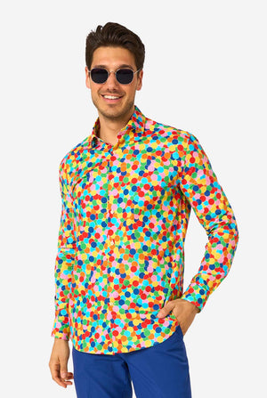 Man wearing a colorful polka dot confetti shirt on a white background. Wearing sunglasses