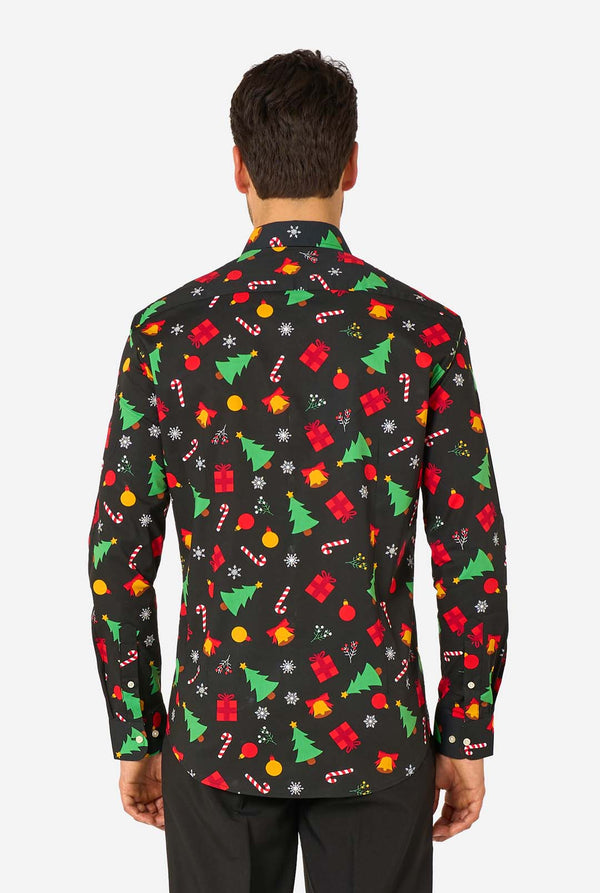 Man wearing a black festive patterned shirt with colorful Christmas designs on a white background. View from the back