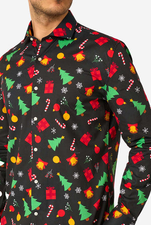 Man wearing a black festive patterned shirt with colorful Christmas designs on a white background. Close up of the chest