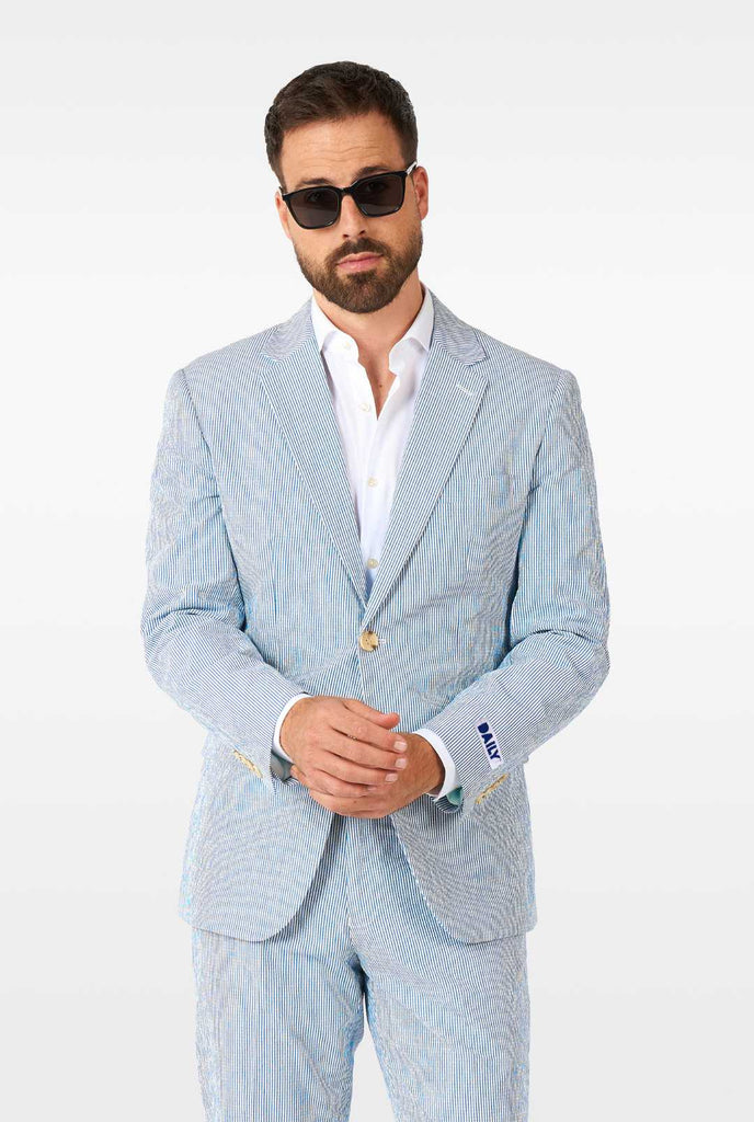 Man wearing stripped blue and white seer sucker suit