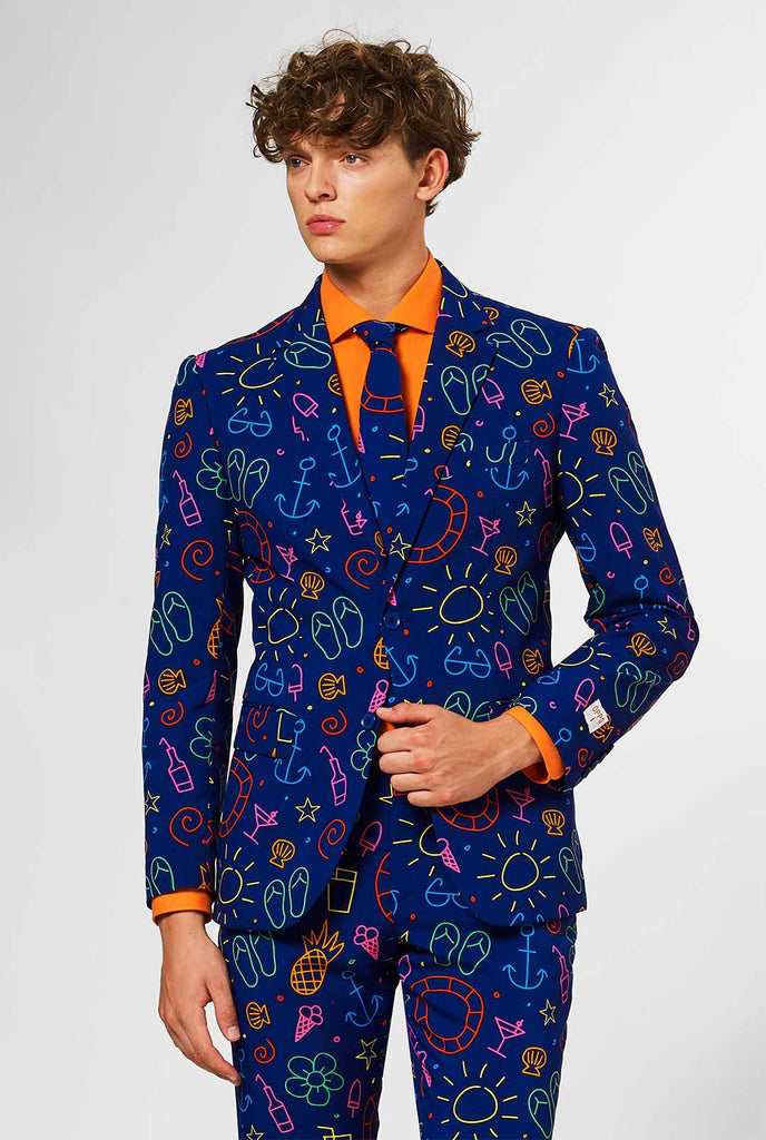 Dark blue men's suit with bright doodle iconography worn by man