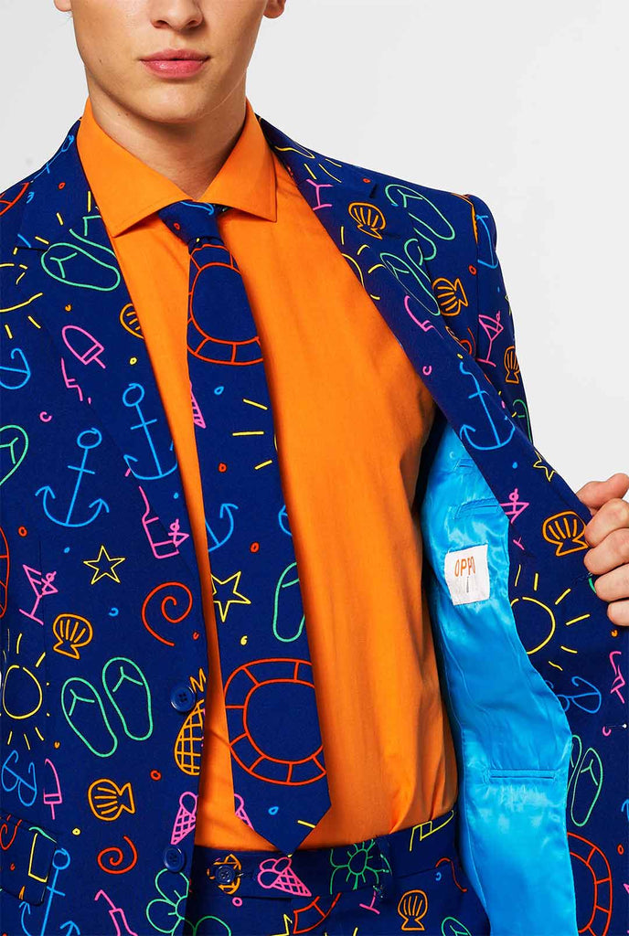 Dark blue men's suit with bright doodle iconography worn by man