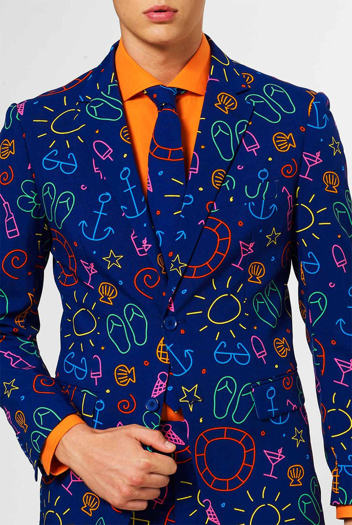 Dark blue men's suit with bright doodle iconography worn by man