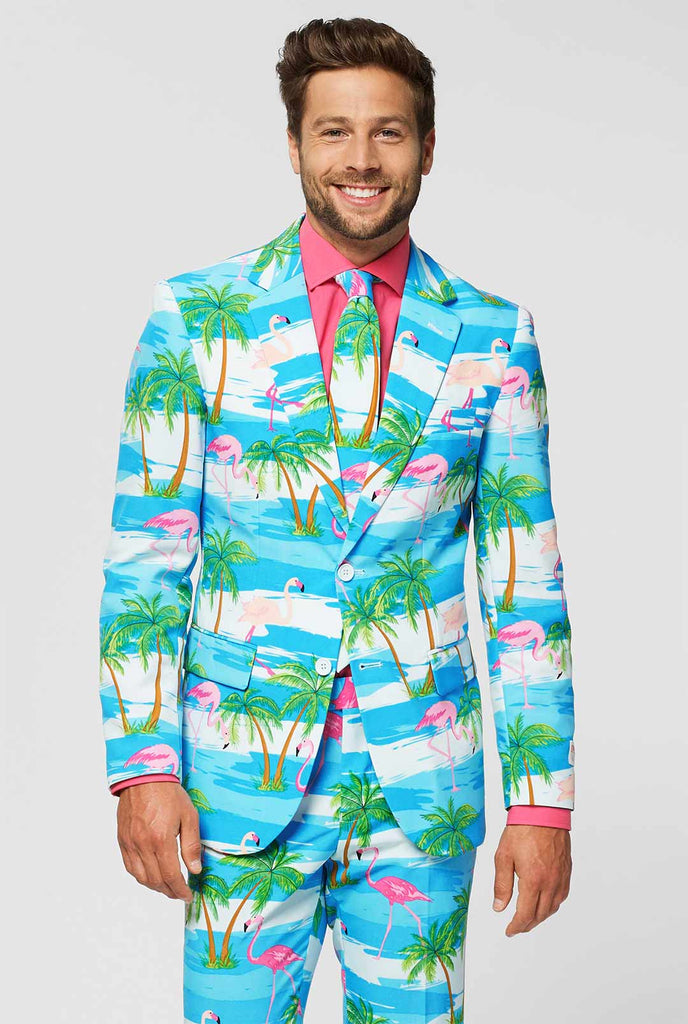 Blue and white men's suit with tropical flamingo print Flaminguy worn by man close up
