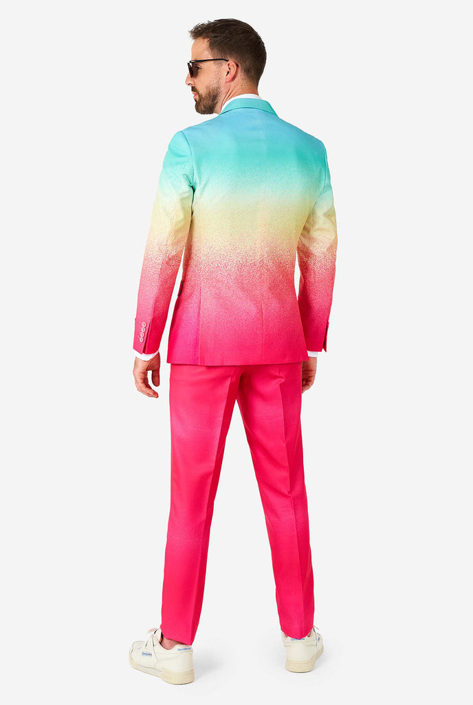 Man wearing rainbow colored suit