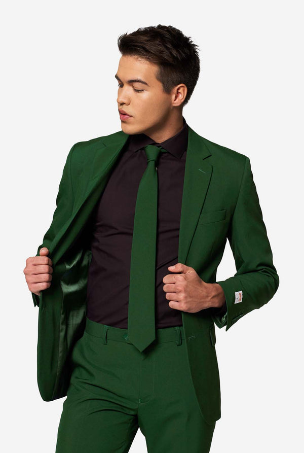 Model showcasing inside lining of OppoSuits Glorious Green suit jacket, paired with a black shirt and green tie — trendy men’s fashion.