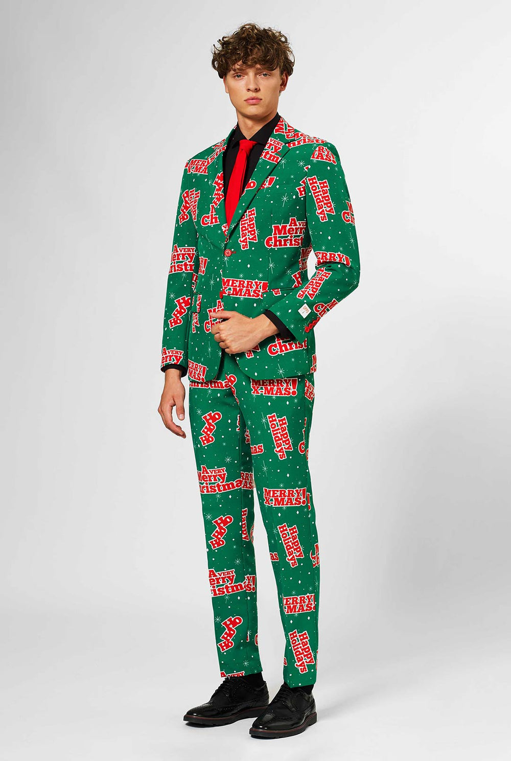 Man wearing green Christmas suit with red Christmas phrases
