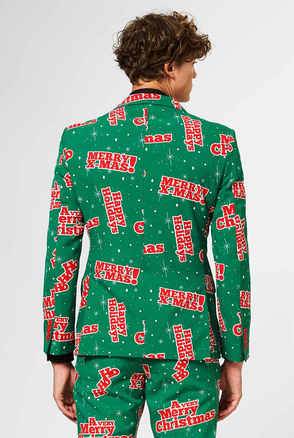 Man wearing green Christmas suit with red Christmas phrases