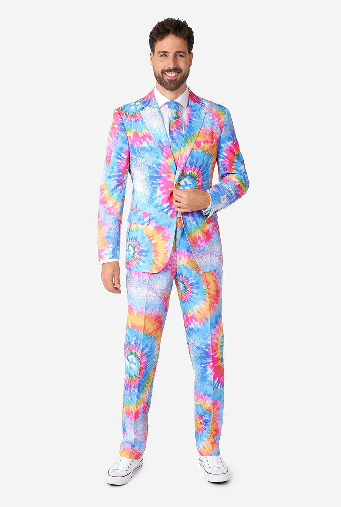 Man wearing pride men's suit with colorful tie dye rainbow print 