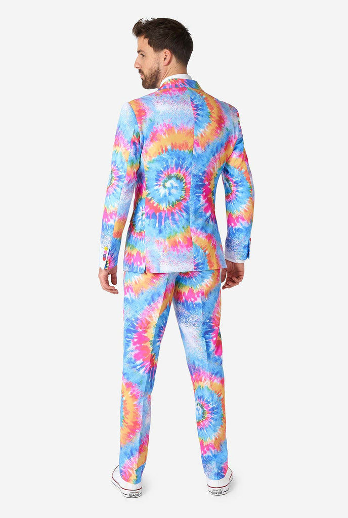 Man wearing pride men's suit with colorful tie dye rainbow print 