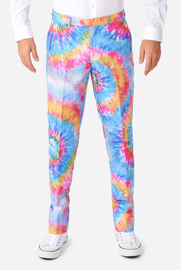 Man wearing pride men's suit with colorful tie dye rainbow print 