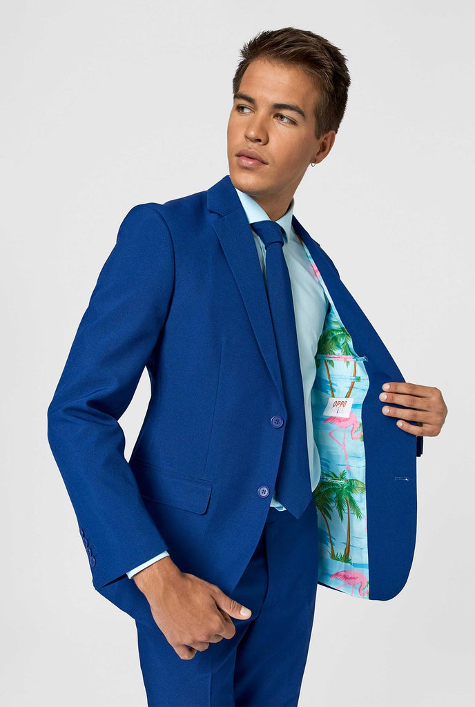 Close up dark blue men's suit with multicolor lining with flamingos worn by man