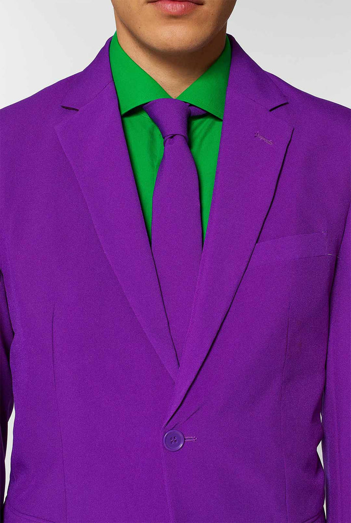 Man wearing purple men's suit and green dress shirt