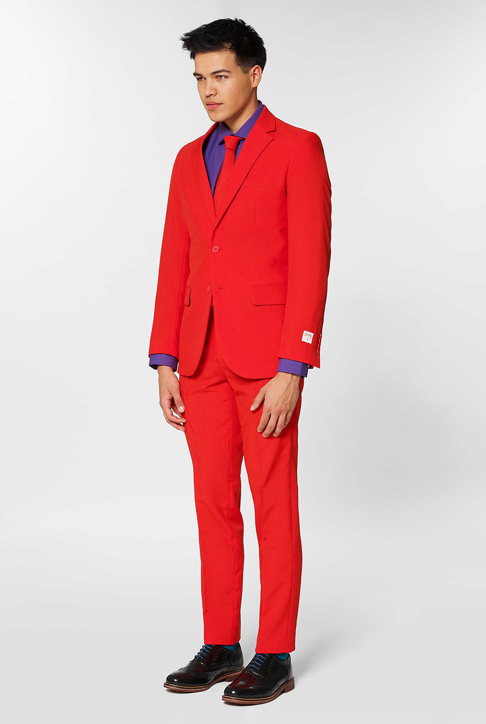 Man wearing red men's suit with purple dress shirt 