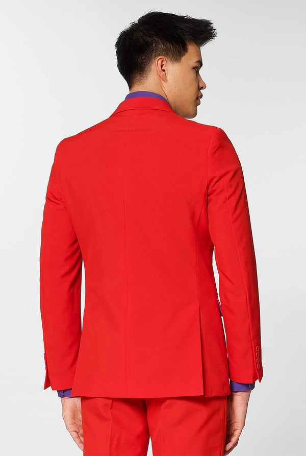 Man wearing red men's suit with purple dress shirt 