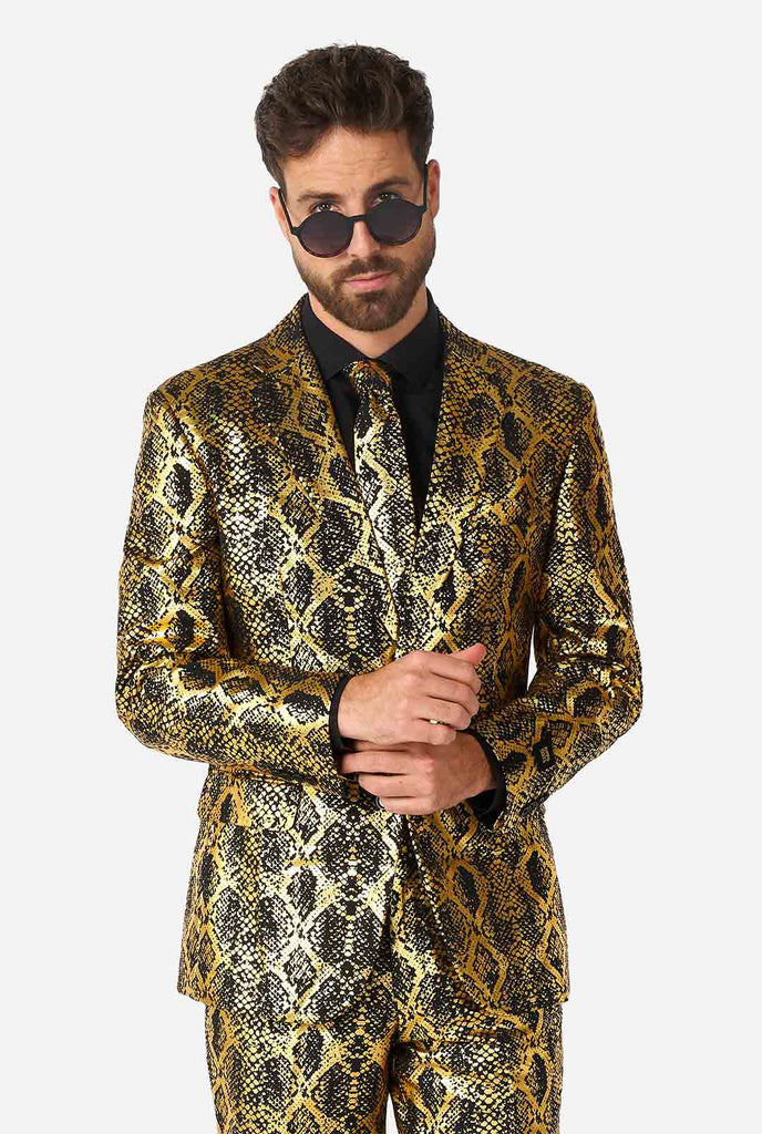 Man wearing suit with, gold and black, snakeskin print