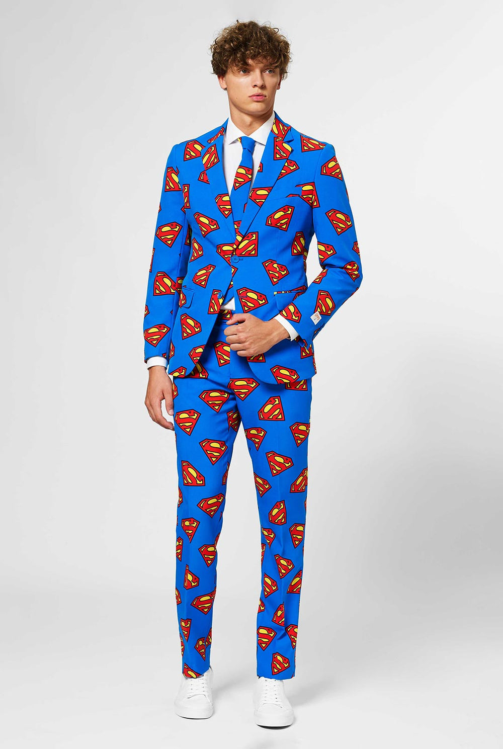 Man wearing blue men's suit with Superman logo print