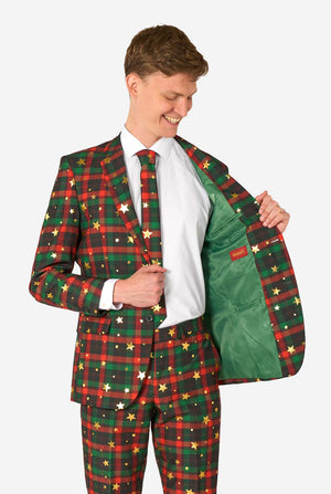 Man in tartan plaid suit with gold star accents holding open the jacket to reveal a solid green interior lining with an OppoSuits label.