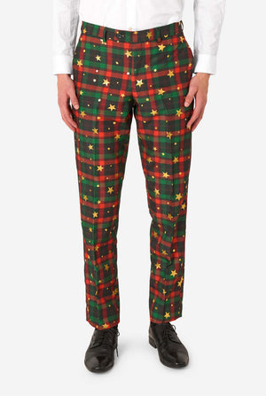 Close-up of tartan plaid suit trousers with gold star and dot accents, paired with black dress shoes