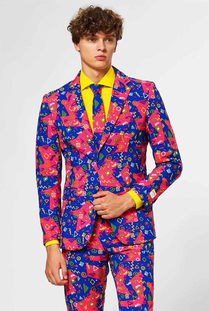 Funky pink and blue men's suit with abstract icons worn by man