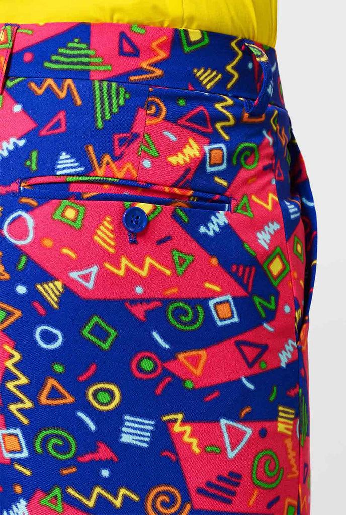 Funky pink and blue men's suit with abstract icons worn by man