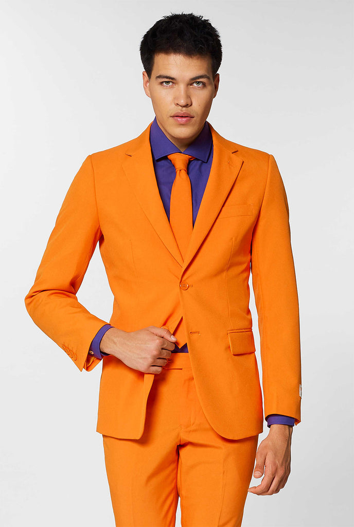 Man wearing orange men's suit with purple dress shirt